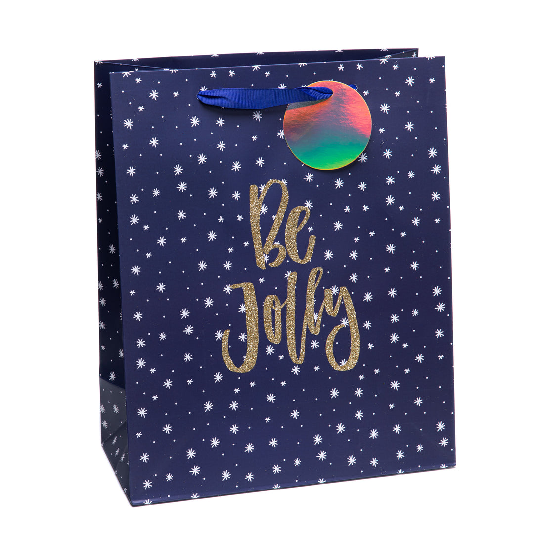 Тъмносиня подаръчна торбичка със златен надпис Be Jolly и малки бели звезди.